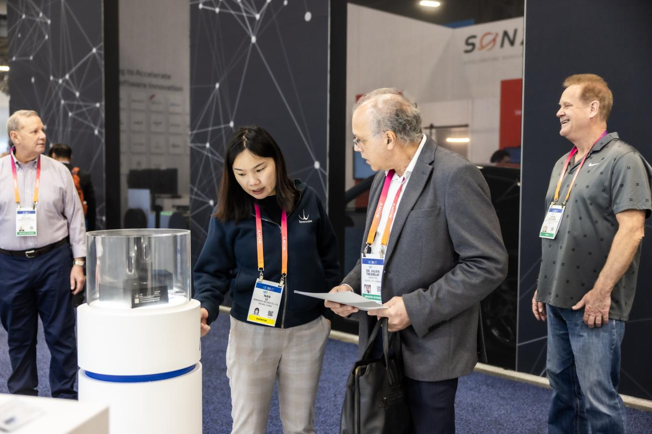 A Benewake representative introduces the AD2 LiDAR display to visitors at CES 2023